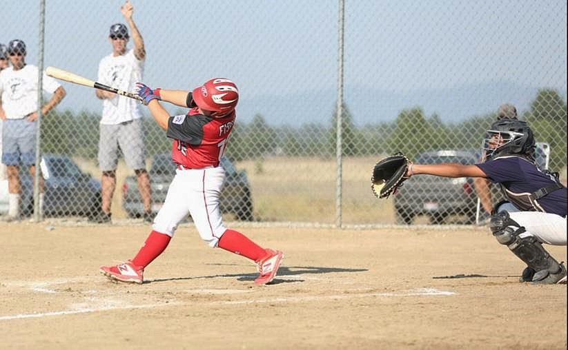 Payton Fisher hits a three-run homer in the second inning of the championship game against Brewster.