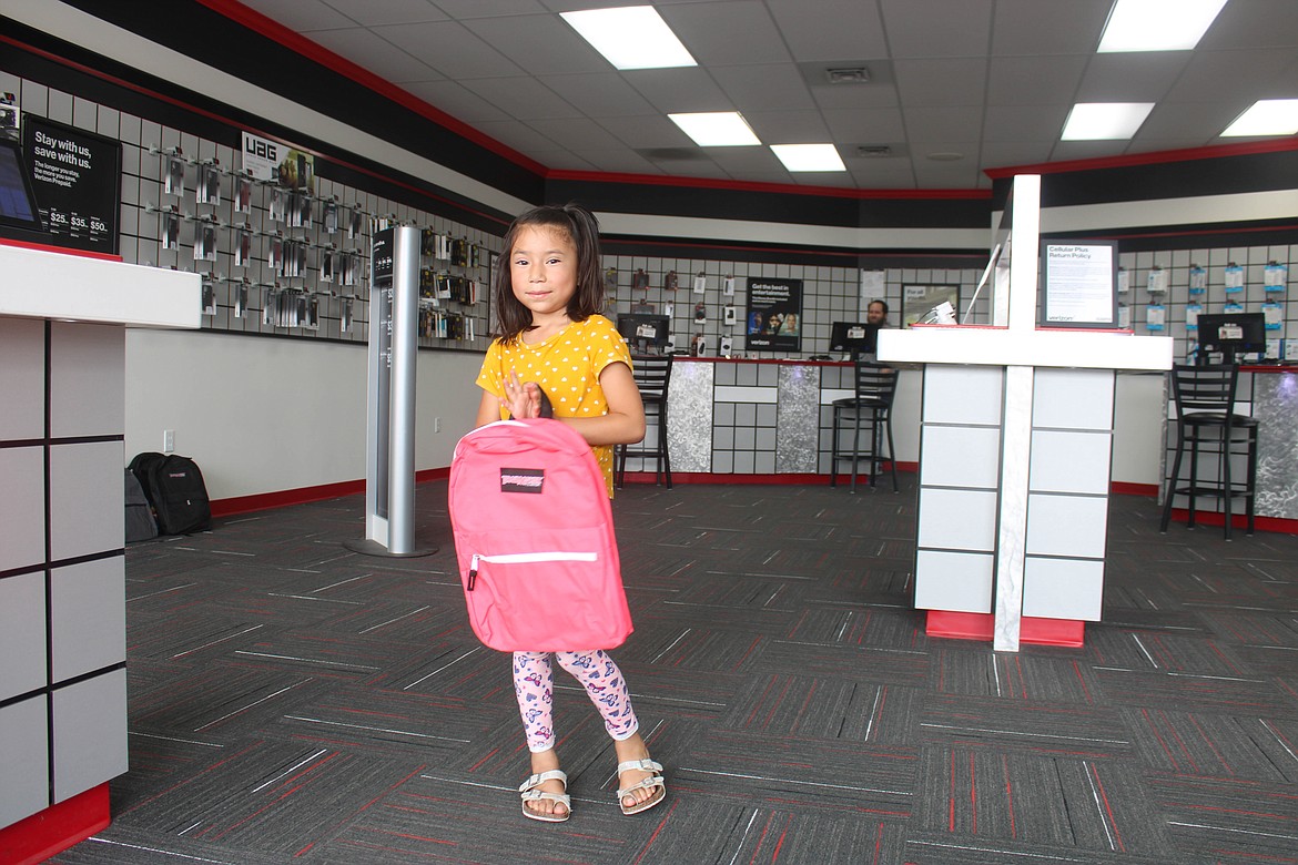 Ephrata student Camilla Bastida smiles with her new backpack at Verizon-Cellular Plus on Saturday.