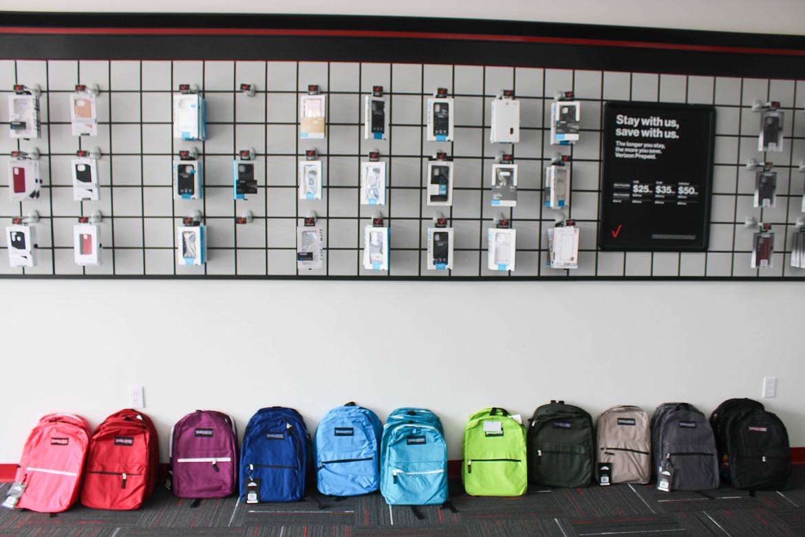 Backpacks line a wall at the Ephrata Verizon-Cellular Plus backpack giveaway on Saturday.