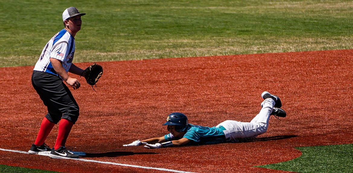 Cruz Martinez slides into the base for the Columbia Basin Riverdogs 15U team at the  Pacific Northwest 13-15 Babe Ruth Regional Tournament in Kelso, Washington last week.