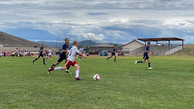 Courtesy photo
Timbers North FC Boys 09 player Luke Fritts dribbles past a player from Wasatch SC last Friday in Park City, Utah.