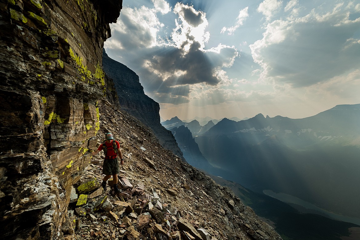 Greg Burfeind hugs a cliff wall during a climb up Mount Merritt in Glacier National Park. (Courtesy of Noah Couser)