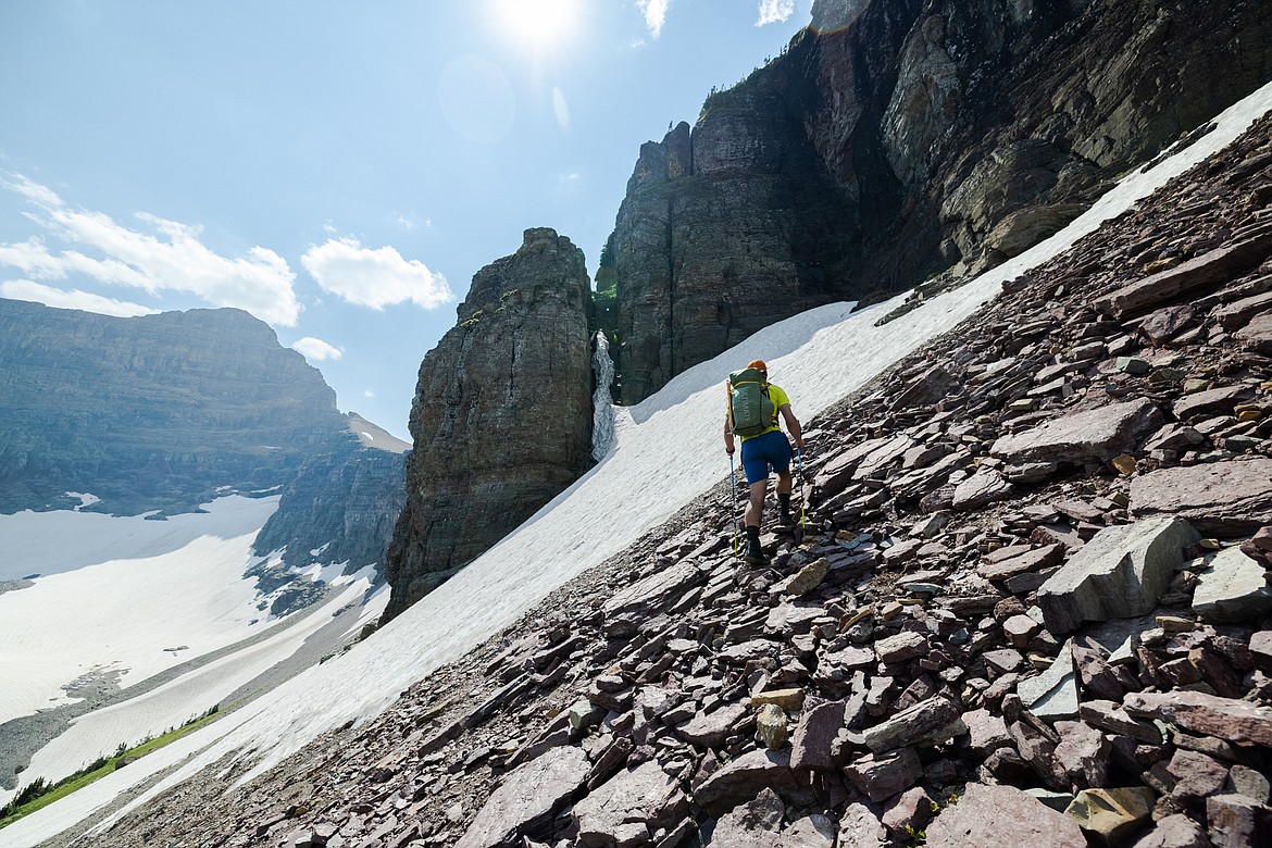 Greg Burfeind surveys a chimney half-filled with snow required to access Almost-a-Dog Pass in Glacier National Park. (Courtesy of Noah Couser)