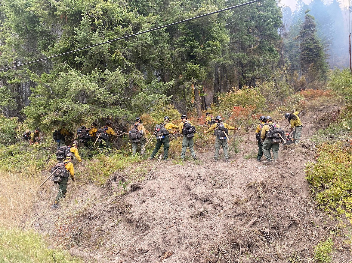 Firefighters cut a handline in the area of the Boulder 2700 Fire east of Polson on Monday.(Inciweb photo)