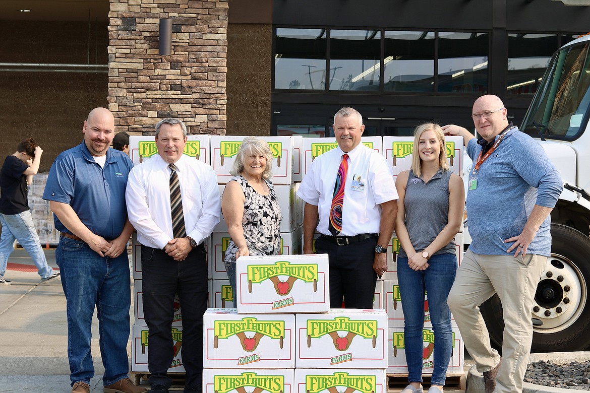 Three organizations teamed up to feed 4,500 pounds of apples to Athol residents. From left, Ned Hughes with Charlie's Produce; Alan Bradetich, Super 1 Foods produce supervisor; Charlotte Hooper, ABC Food Bank director; Randy Wilson, Super 1 Foods store director; Aimee Bach, FirstFruits representative; and Tim Hendricks with Charlie's Produce. HANNAH NEFF/Press