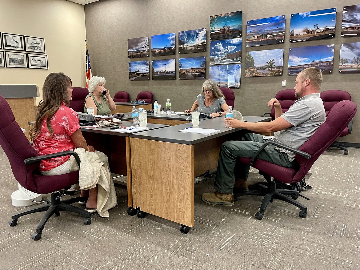 Moses Lake School Board members (left to right) Shannon Hintz, Susan Freeman, board president Vickey Melcher, and Elliott Goodrich, sit at desks and are joined on the phone by Alana DeGooyer, following Tuesday morning’s 90-minute long special board meeting, which was entirely an executive session devoted to discussing a personnel matter.