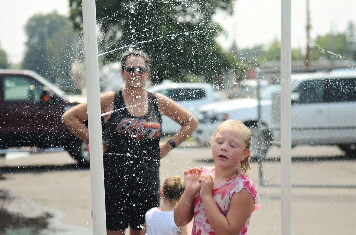 While players and fans roasted in the heat at the Pioneer Days 3 on 3 basketball tournament, some smart cookies kept it on the cool side. (Carolyn Hidy/Lake County Leader)