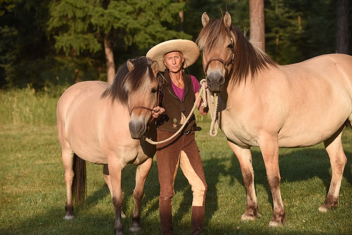 "Lady Long Rider" Bernice Ende shows off two of her faithful companions at her home in Trego. Ende will be inducted into the Montana Cowboy Hall of Fame and Western Heritage Center the weekend of Aug. 13. (Scott Shindledecker/Daily Inter Lake)