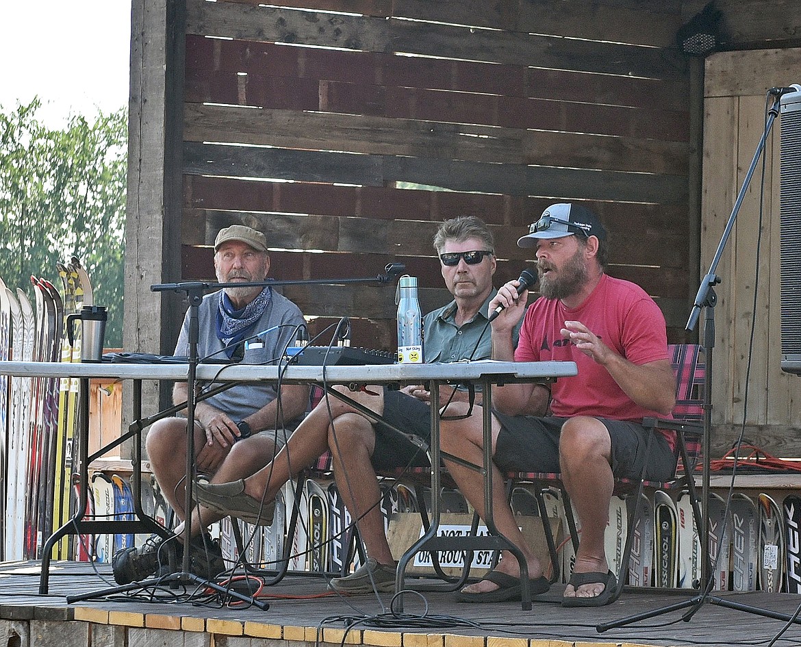 Montana Tap House owner Ed Docter, right, alongside Whitefish contractor Casey Malmquist and Whitefish Planning Board member Toby Scott, addresses a group of around 60 business owners and residents gathered outside the tap house at an affordable housing meeting organized by Docter on Monday, July 26, 2021. (Whitney England/Whitefish Pilot)