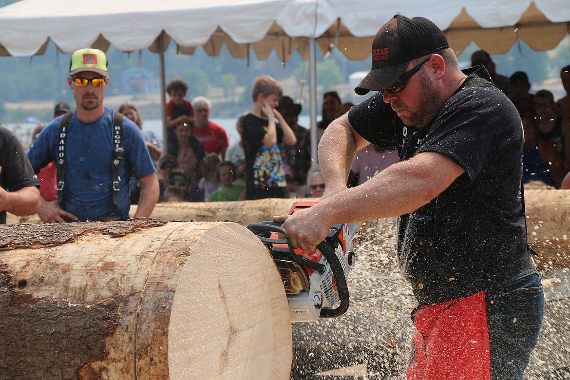 A competitor races to saw through a log during Saturday's Timber Days competition.