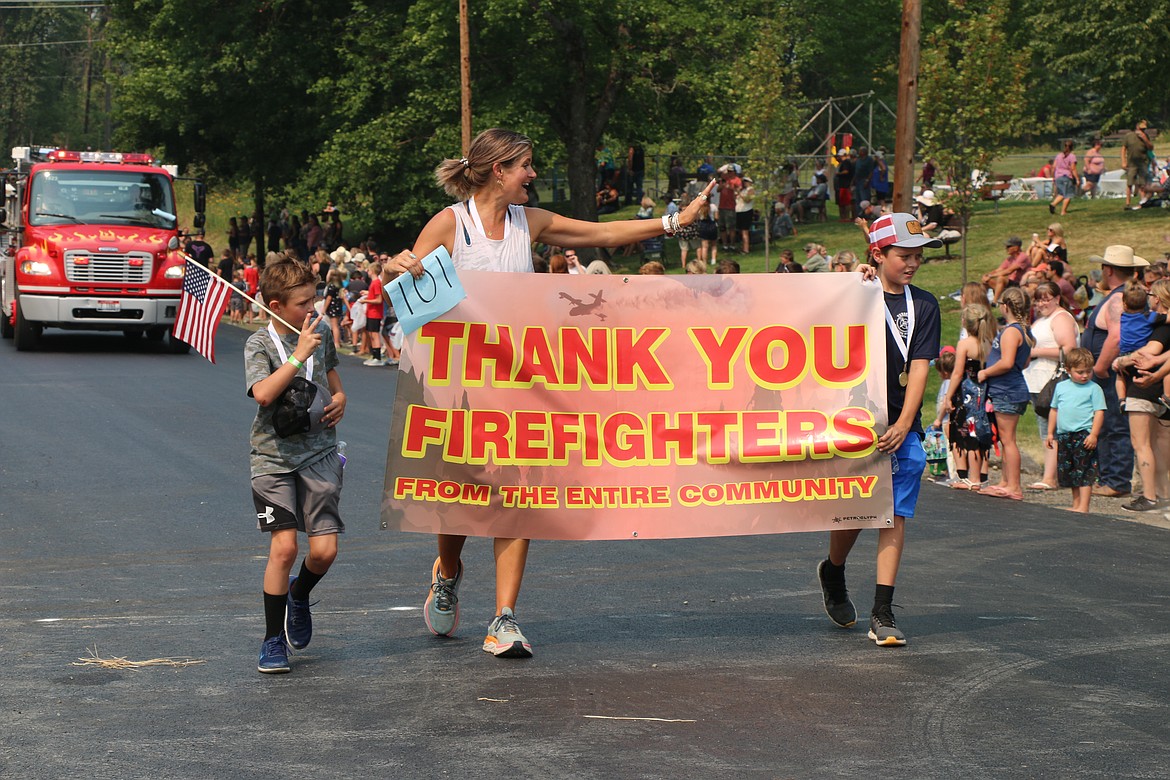 Timber Days parade participants carry a message of support and thanks to crews fighting the nearby Pioneer Fire.