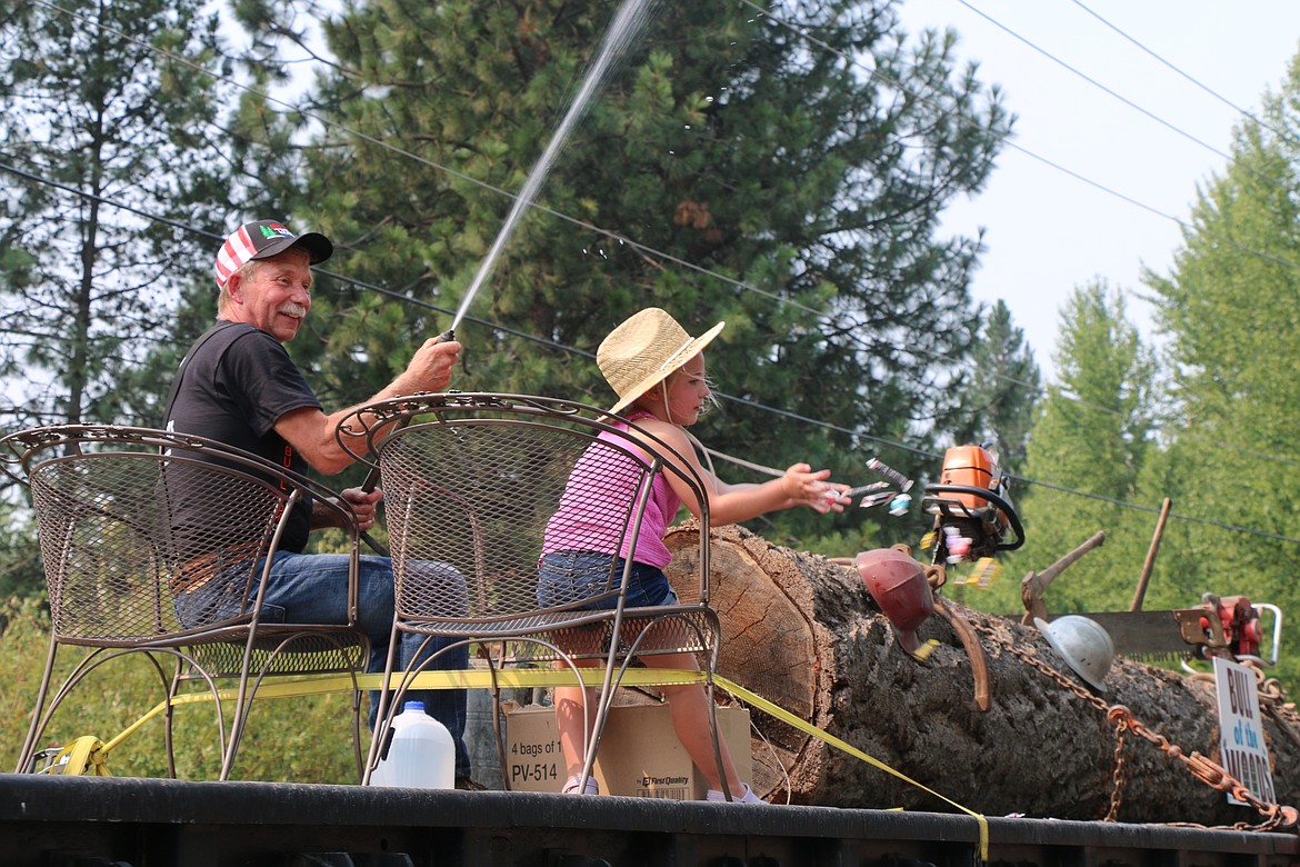 Bull of the Woods 2021 Rick Pettit aims at the crowd with a hose as he rides on a float during Saturday's Timber Days parade.