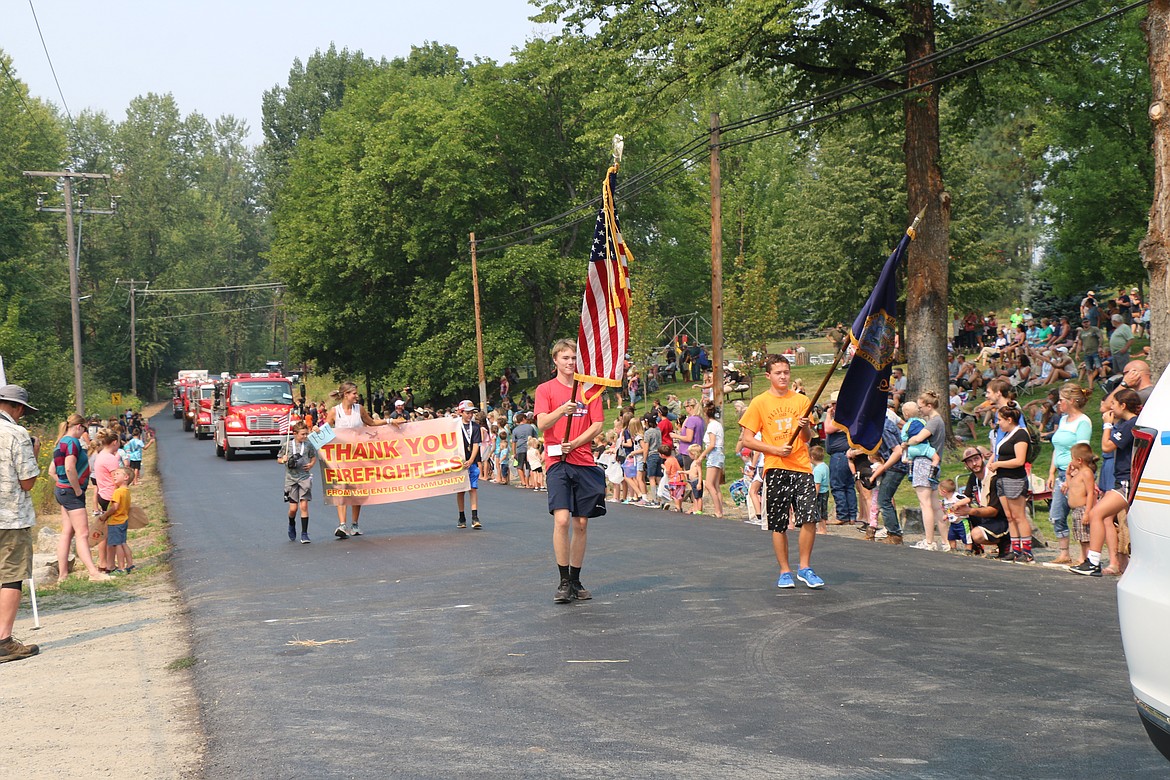 Ethan Korff and Dylan Lord carry the colors during Saturday's Timber Days parade.
