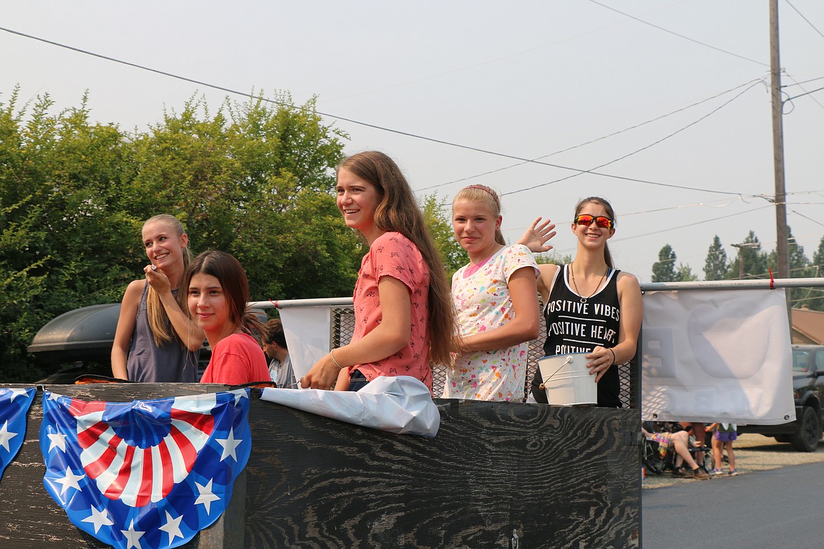 Parade participants wave to the crowd during Saturday's Timer Days parade.