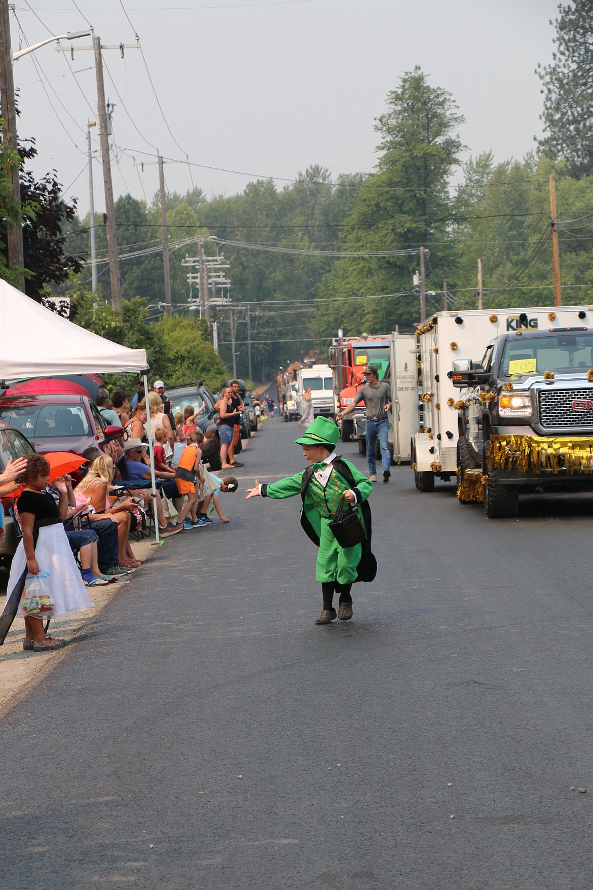 A young leprechaun passes out candy during Saturday's Timber Days parade.