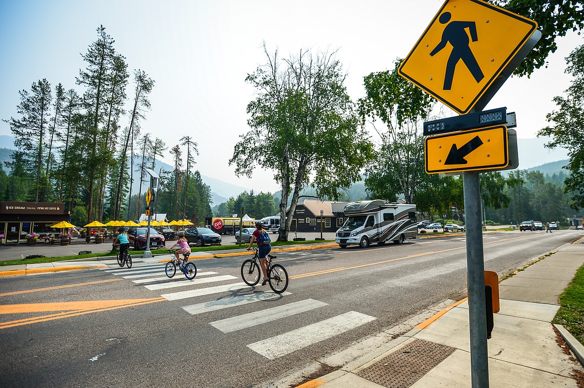 Bicyclists cross the Going-to-the-Sun Road in West Glacier on Wednesday, Aug. 4, 2021. (Casey Kreider/Daily Inter Lake)