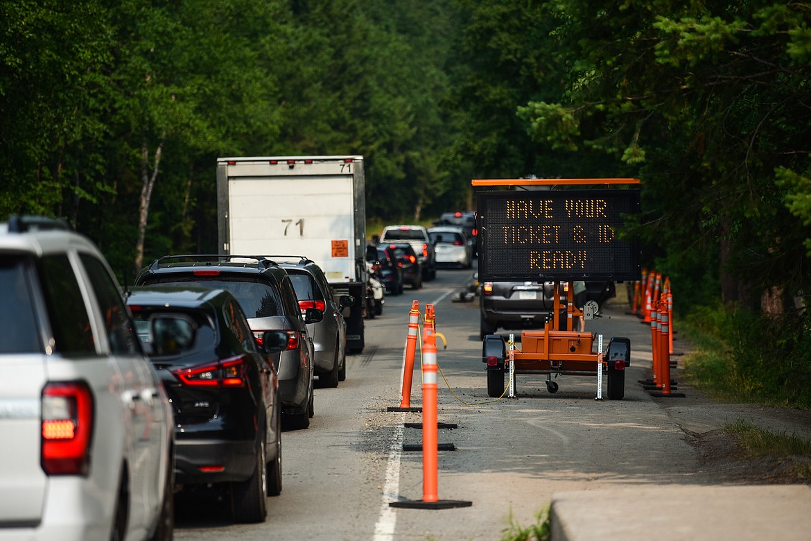 A line of vehicles waiting to enter Glacier National Park extends to the bridge over the Middle Fork of the Flathead River in West Glacier on Wednesday, Aug. 4, 2021. (Casey Kreider/Daily Inter Lake)