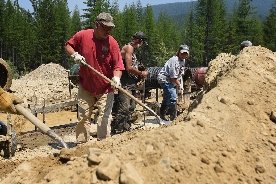 Northwest Montana Gold Prospectors member Ron Maupin and his fellow members shovel material into several trommels at the groups claim on Libby Creek. (Jeremy Weber/Daily Inter Lake)