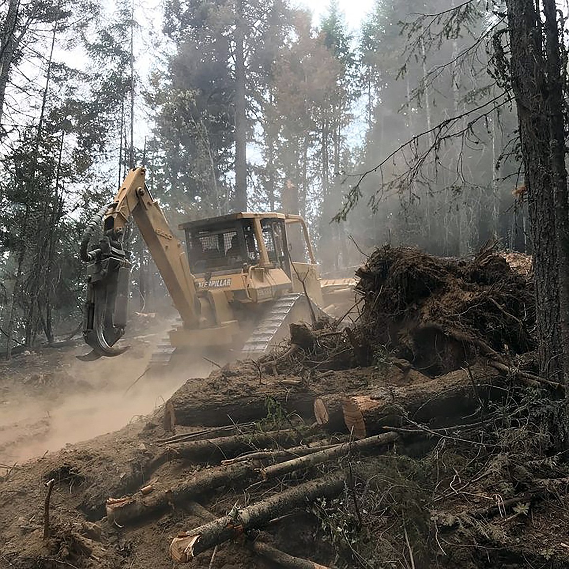 Firefighters work on the Pioneer Fire on Aug. 1. The fire was deemed 100% contained on Wednesday.