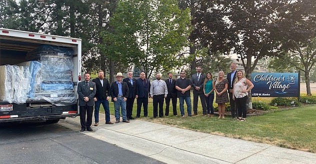 On hand to deliver a truck full of new mattresses to residents at Children's Village are Freemasons from the Rathdrum Masonic Lodge # 41: (from Left) Dan LaVine, Nathan Bendel, Matt Griffin, Andrew Evenson, Mike Meline, Trever Sams, James Childs, Danny Osburn and Scott Tollackson and from Children's Village, chief program officer Rosa Mettler, board members Toni Capaul and Christopher Liermann and interim CEO Vanessa Moos.