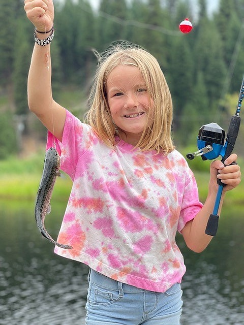 T.J. Ross photo
Teagan Ross shows off a stocked rainbow trout she caught in region 2 at the Red River.