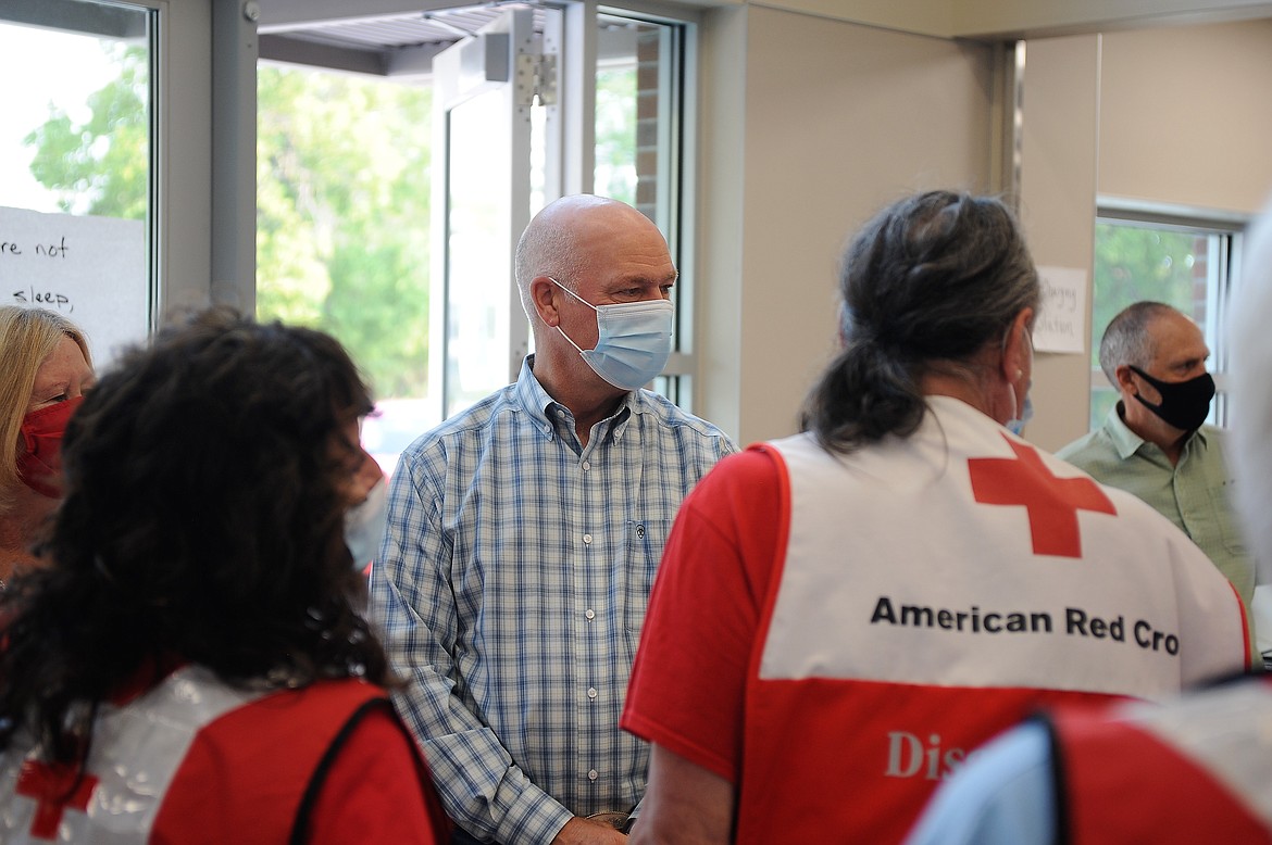 Montana Gov. Greg Gianforte visits Red Cross volunteers at Linderman Elementary School in Polson, the site of a shelter for people displaced by the nearby Boulder 2700 Fire, on Thursday, Aug. 5, 2021.