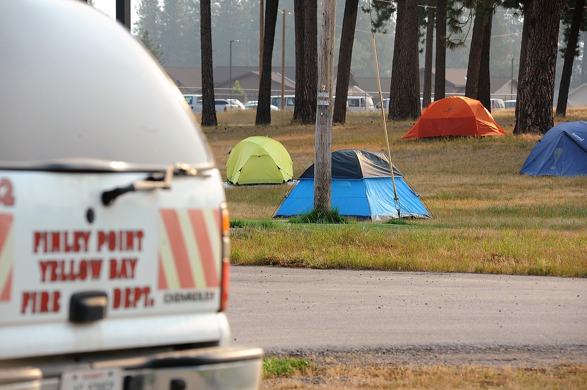 Between long shifts fighting the Boulder 2700 Fire near the east shore of Flathead Lake, firefighters camp in tents in a field at Salish Kootenai College in Pablo, seen on Thursday, Aug. 5, 2021.