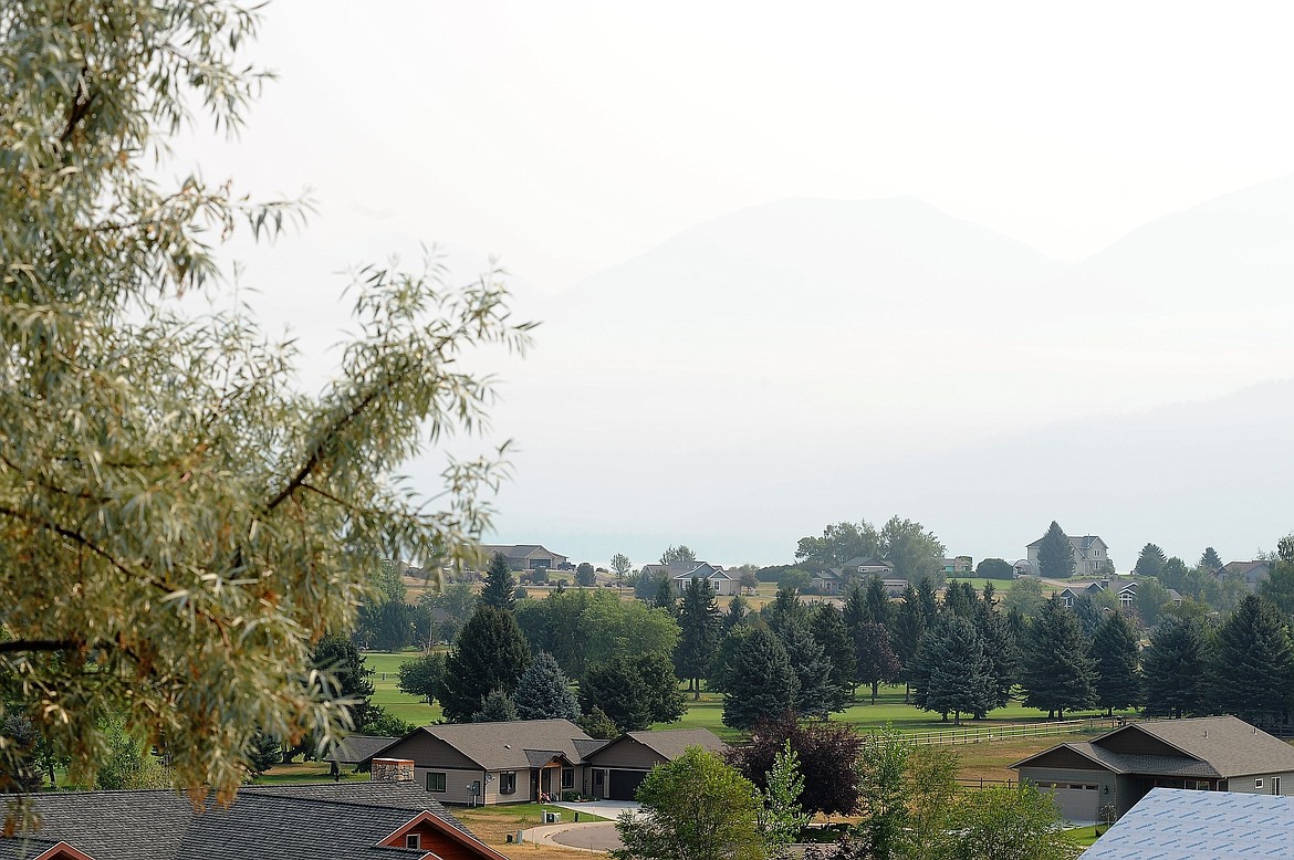 The Mission Mountains are barely visible from a vantage point in Polson on Thursday, Aug. 5, 2021, amid dense smoke from the Boulder 2700 Fire on the east shore of Flathead Lake.