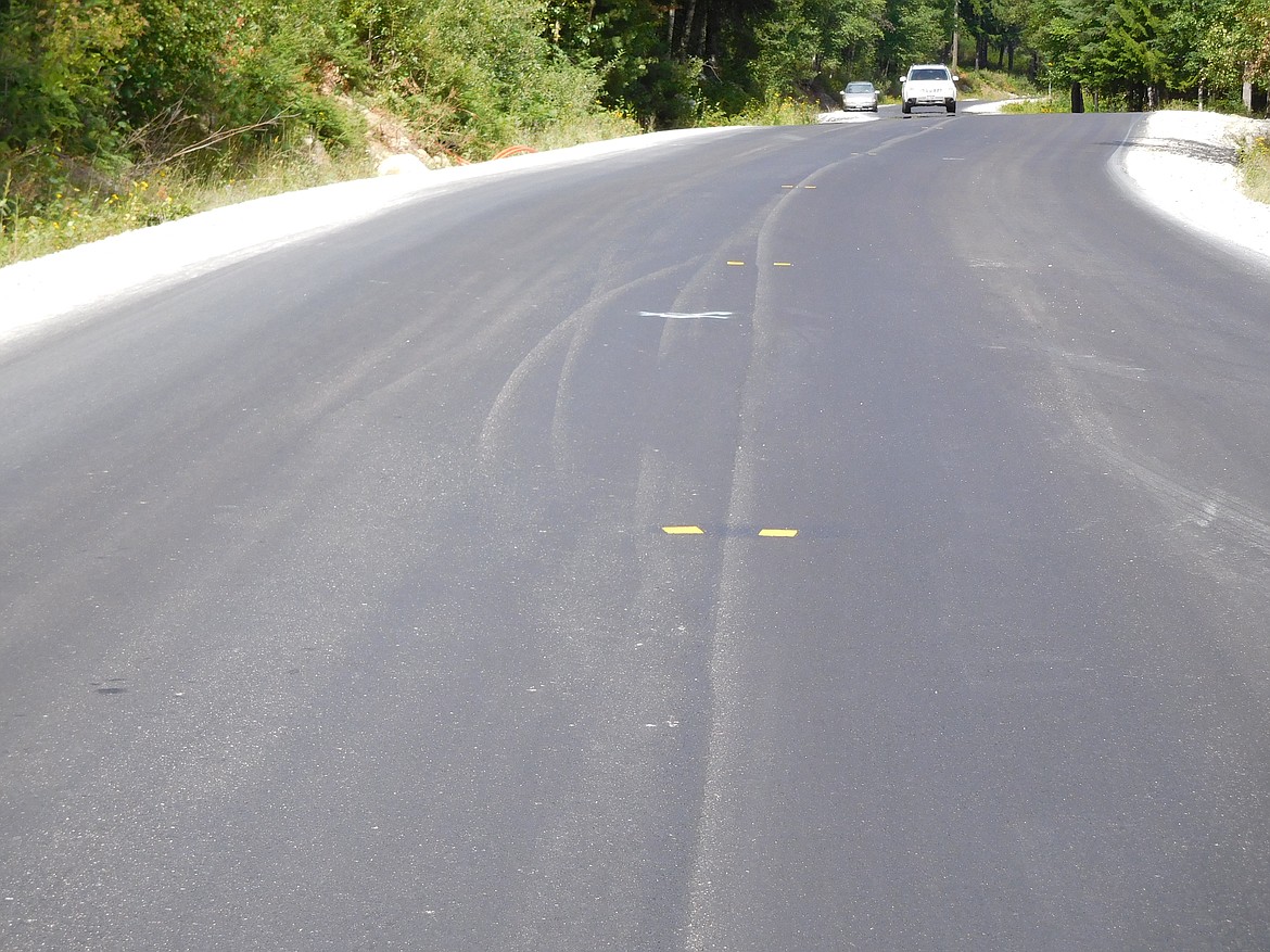 Pictured is Schweitzer Mountain Road after the repaving process. Yellow reflective thermoplastic markers identify the centerline of the road. These markers are useful for identifying the location of the centerline after other identifiers, mainly paint, is scrapped away due to heavy snow removal through the winter months.