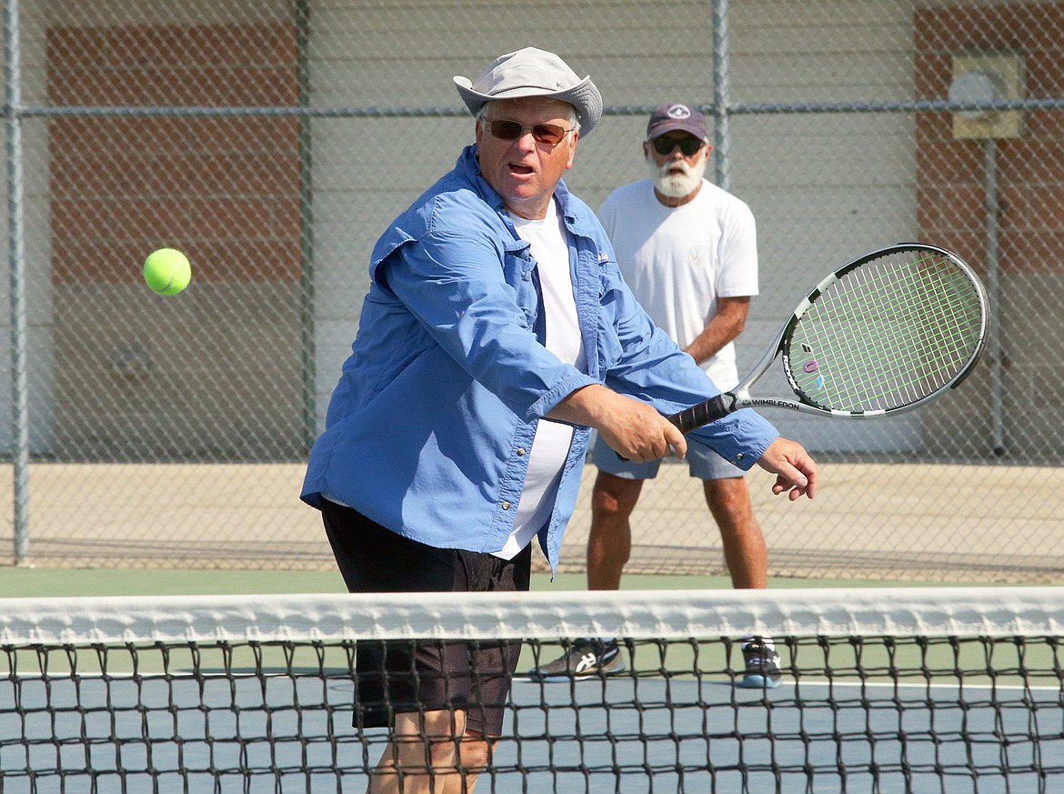 Randy Poole returns a shot during a morning match with his senior friends at Lake City High School.