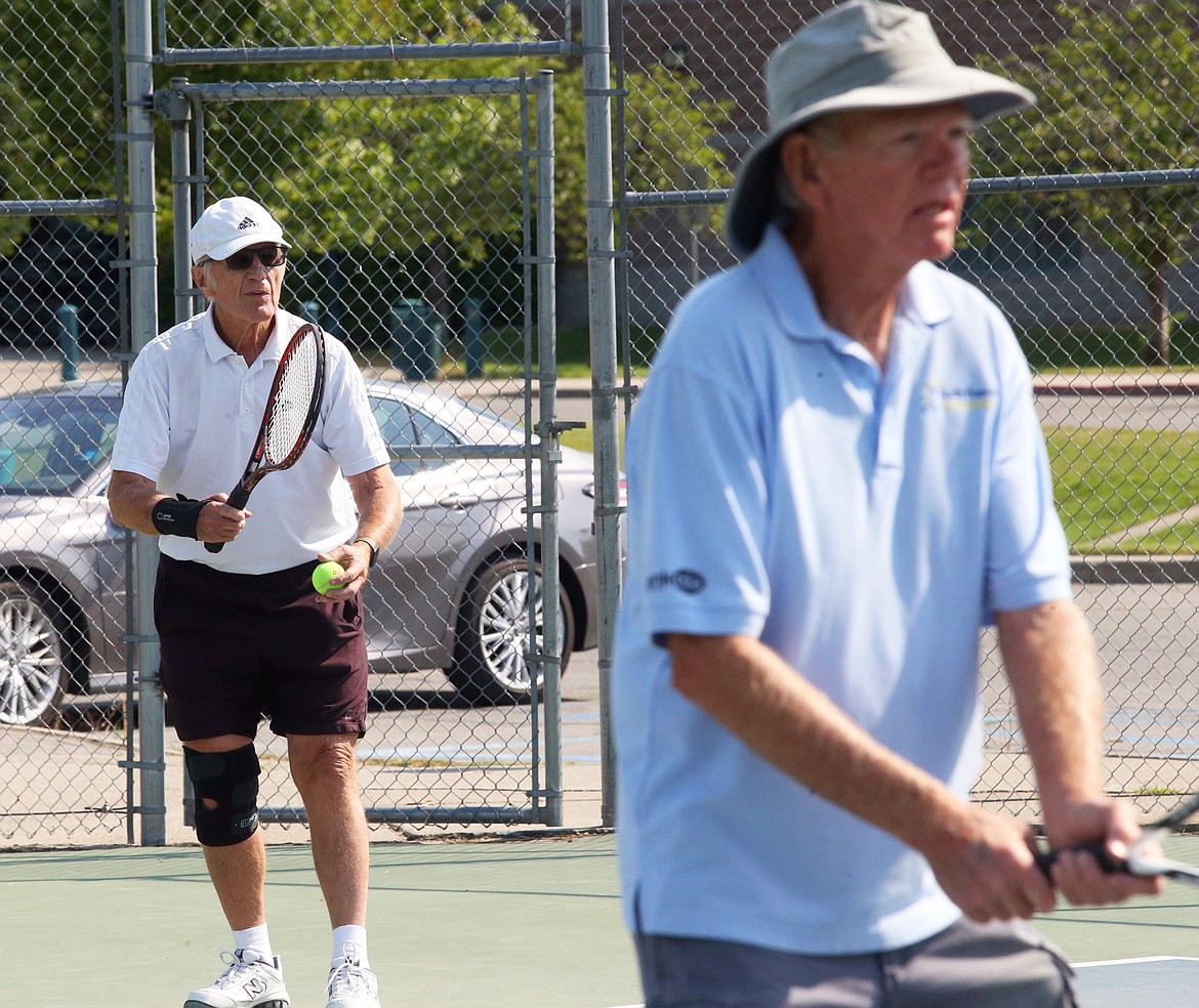 Don Wold prepares to serve while doubles partner Mike Cheeley readies for the return.