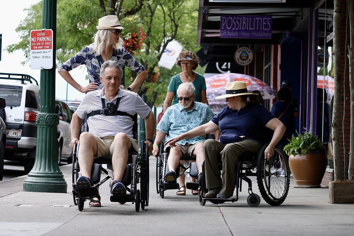 City officials took a tour on wheelchairs on Sherman Avenue Friday to better understand the challenges faced by the disabled community. From left: Marie Widmyer, Mayor Steve Widmyer, Cory English, Councilman Dan English, and volunteer Blair Williams. HANNAH NEFF/Press