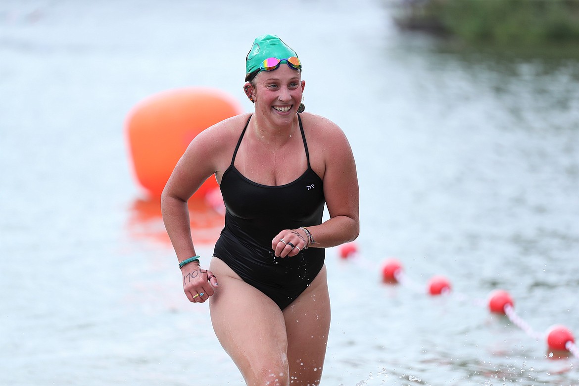 Emily Renzini smiles as she closes in on the finish line of the 26th annual Long Bridge Swim on Saturday.