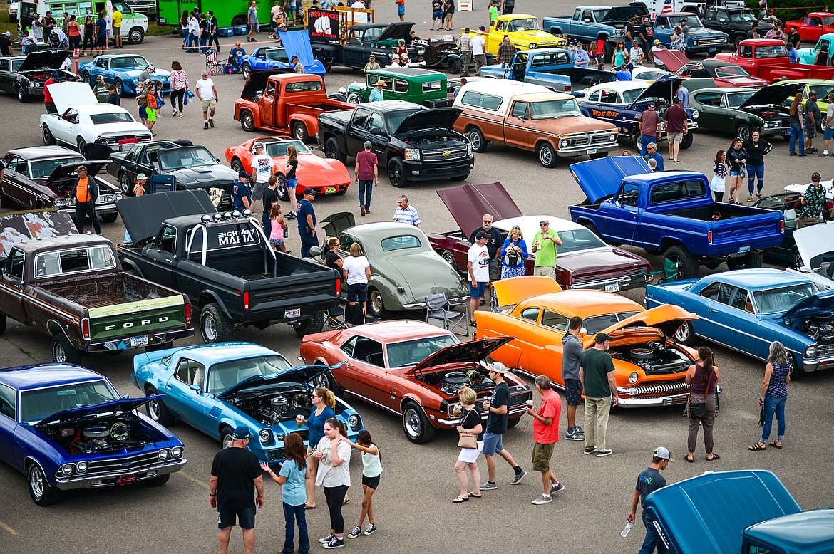 Visitors check out rows of cars and trucks on display at the Evergreen Show 'N Shine at Conlin's Furniture on Saturday, Aug. 7. (Casey Kreider/Daily Inter Lake)