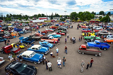 Visitors check out rows of cars and trucks at the Evergreen Show 'N Shine on Saturday, Aug. 7. There were around 225 vehicles on display in the parking lot of Conlin's Furniture in Evergreen. (Casey Kreider/Daily Inter Lake)