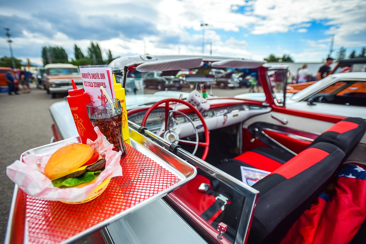 A drive-in tray with a decorative cheeseburger, fries and Coca-Cola hang from the window of a 1959 Ford Galaxie at the Evergreen Show 'N Shine at Conlin's Furniture on Saturday, Aug. 7. (Casey Kreider/Daily Inter Lake)