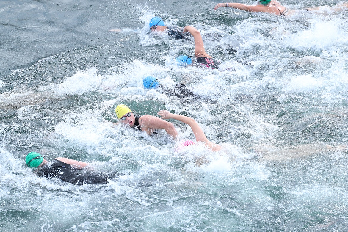 Swimmers take off from the start line on Saturday.