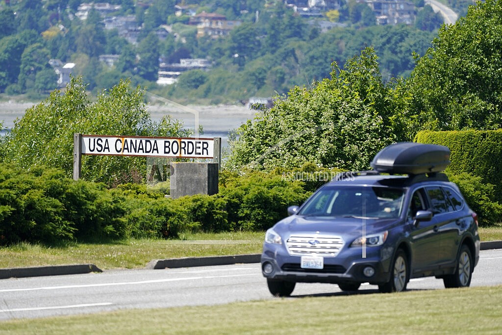 In this June 8, 2021, file photo, a car heads into the U.S. from Canada at the Peace Arch border crossing in Blaine, Wash. Canada is lifting its prohibition Monday, Aug. 9, on Americans crossing the border to shop, vacation or visit, but the United States is keeping similar restrictions in place for Canadians. The reopening Monday is part of a bumpy return to normalcy from COVID-19 travel bans. (AP Photo/Elaine Thompson, File)