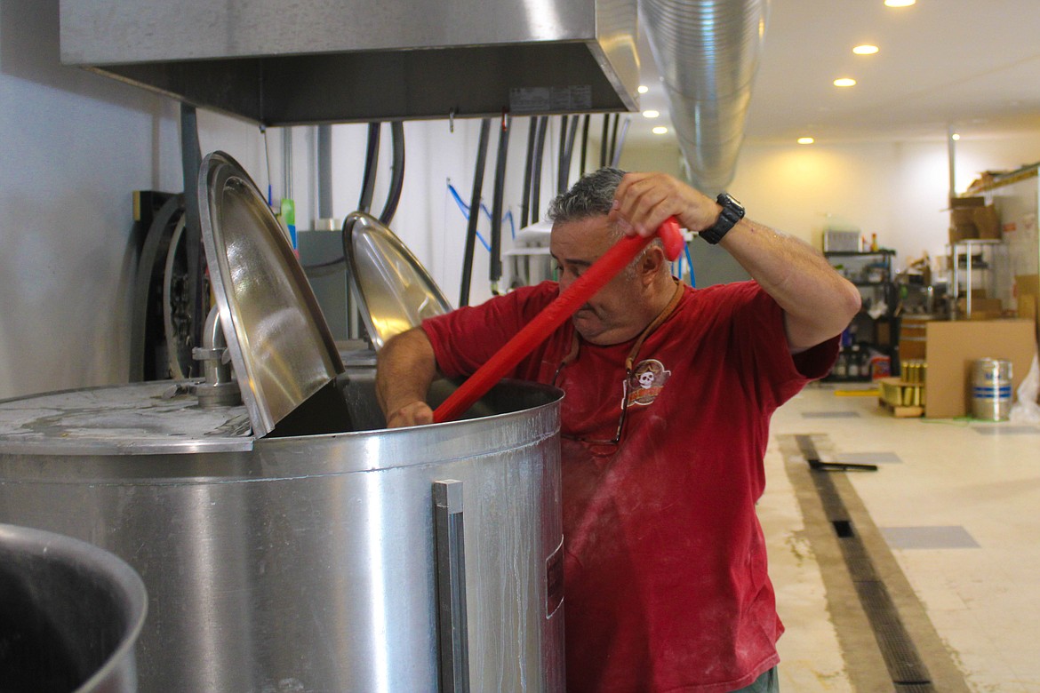 Squirrel Fight co-owner Ruben Vela mixes a wheat ale in the morning before the taproom opens.