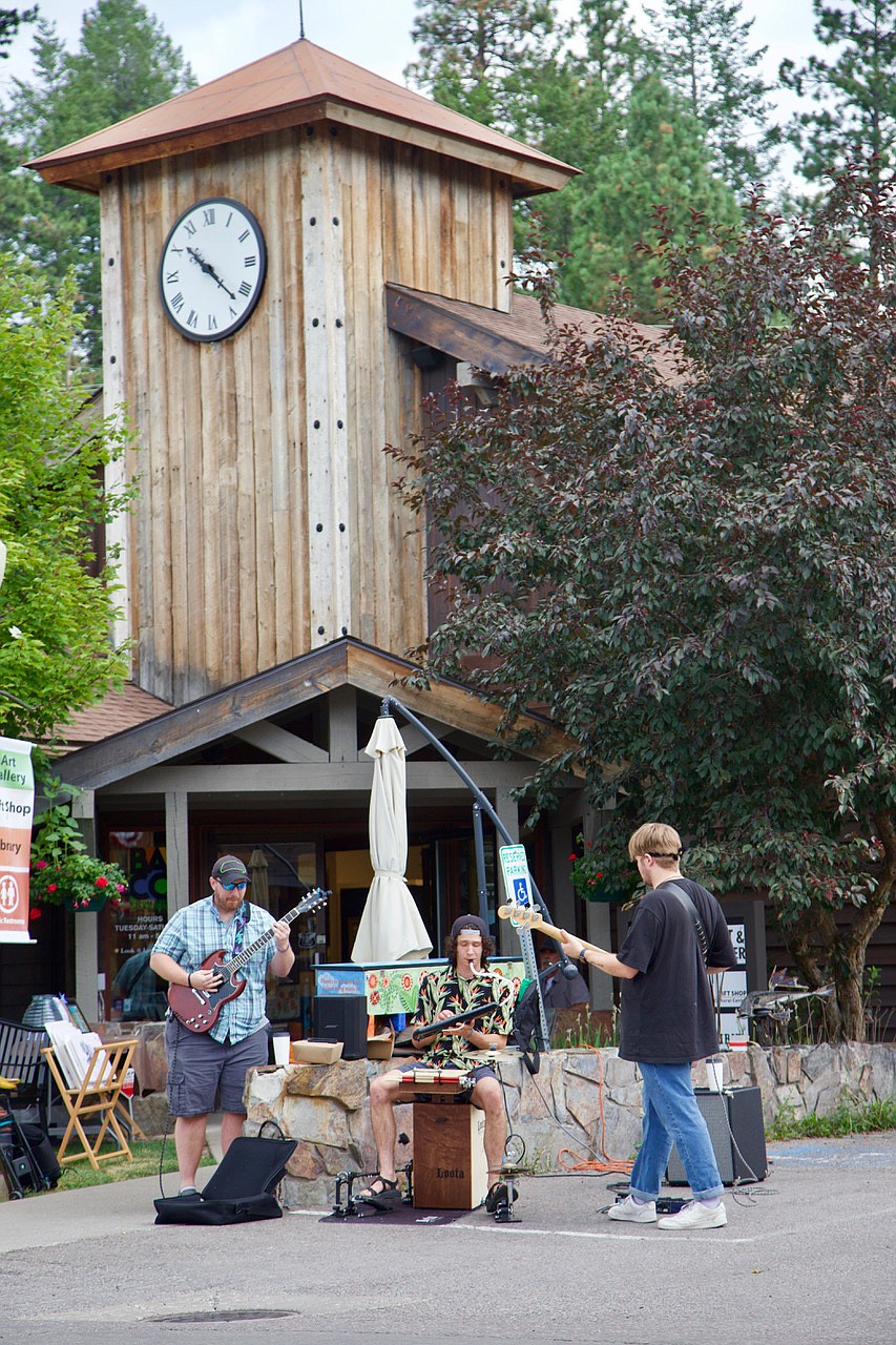 A musical ensemble that includes the unique sounds of a melodica plays in front of the Bigfork Art and Cultural Center. (Kay Bjork photo)