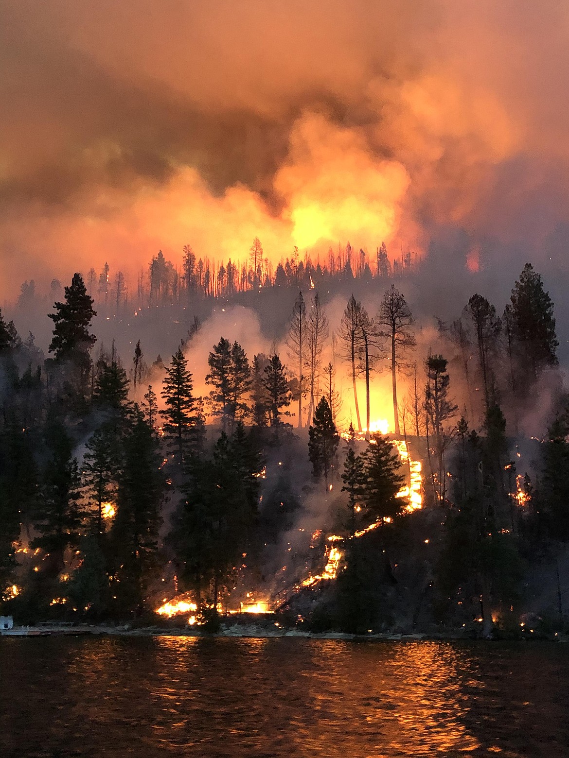 A burning stairway resembles a lava flow as the Boulder 2700 Fire scorches the east shore of Flathead Lake in the early morning of Sunday, Aug. 1. (Courtesy of Nathan Smith)