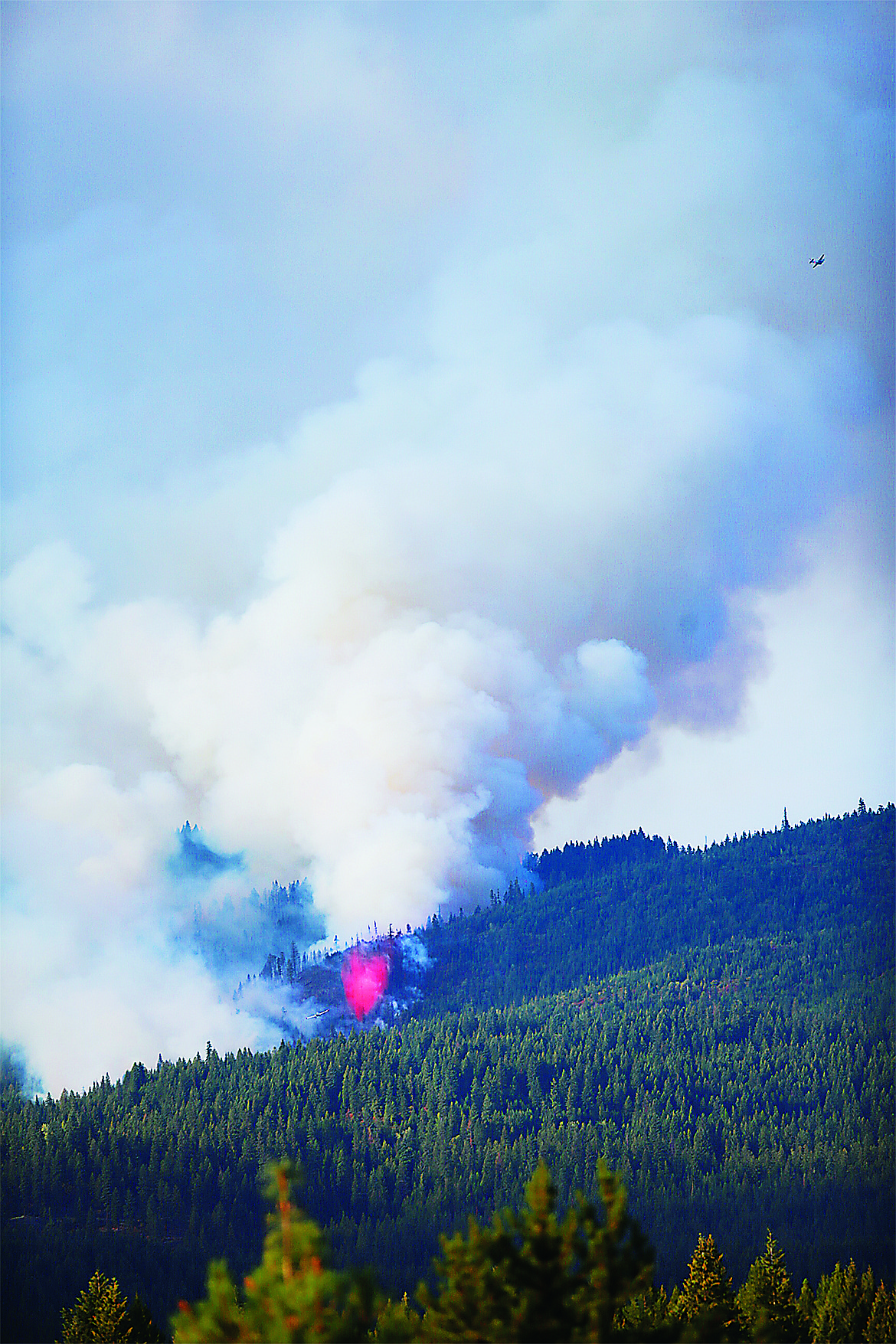 Planes circle the Three Sisters Fire in the Bayview area Tuesday afternoon. The fire reached the size of 20 acers as of 7:30pm Tuesday evening.