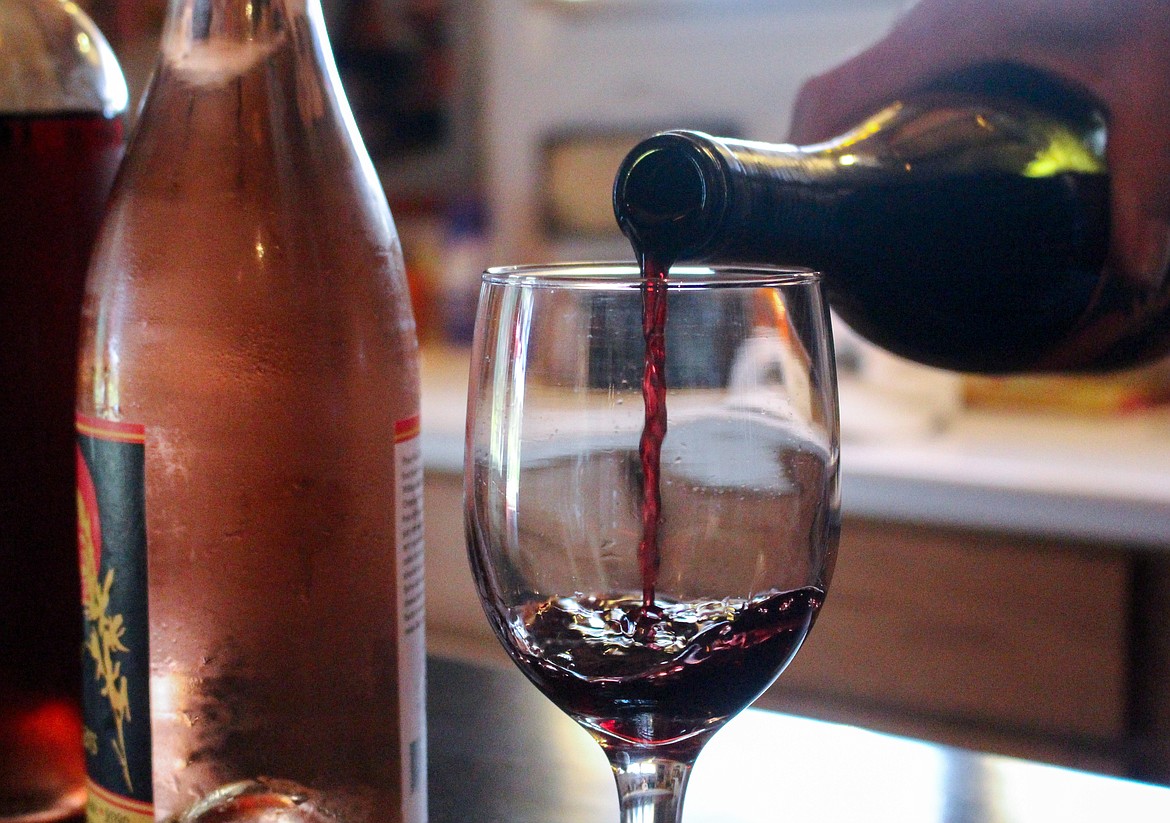 Nancy Parr pours a glass of red wine inside the tasting room at Camas Cove Cellars in Moses Lake on July 10.