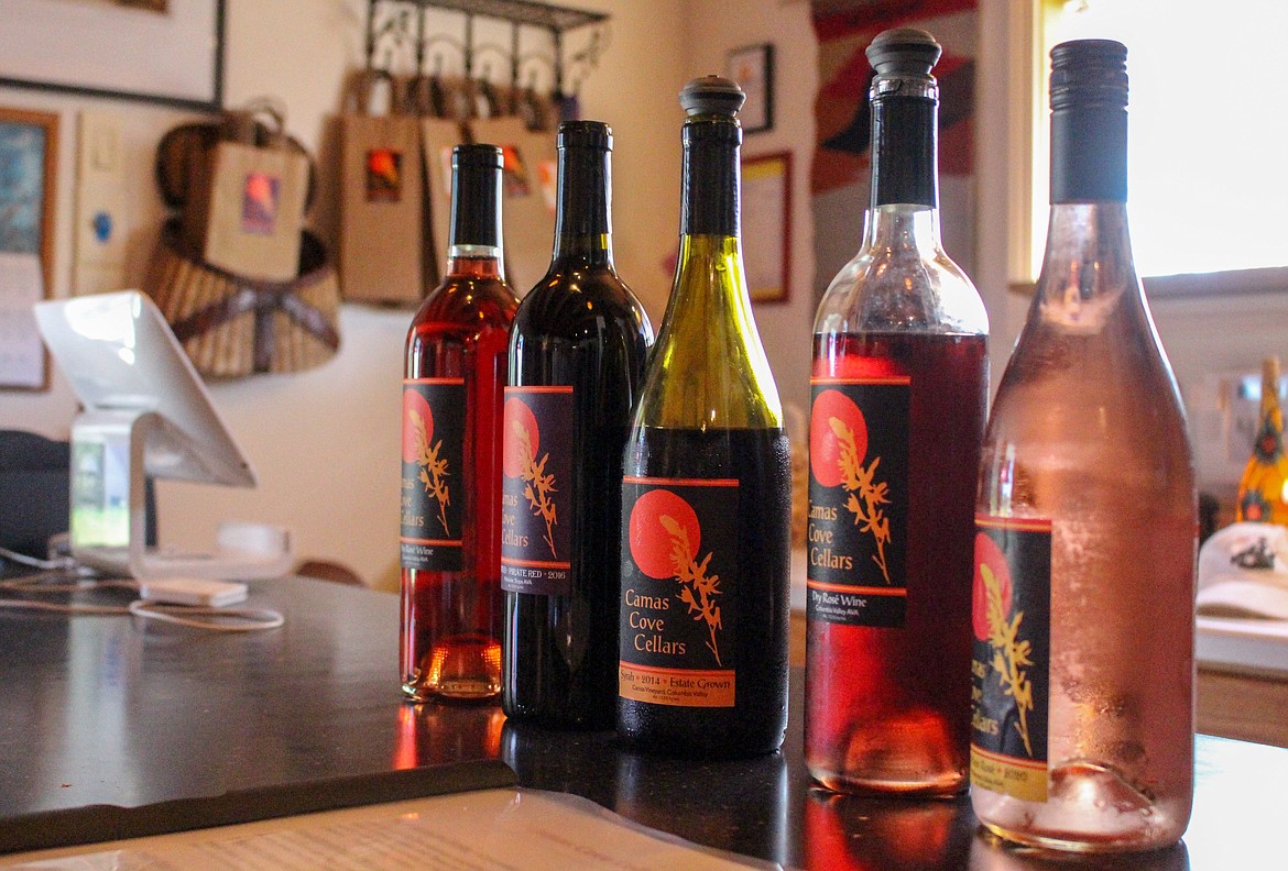 A row of Camas Cove wines sit atop the counter in the tasting room at Camas Cove Cellars in Moses Lake on July 10.