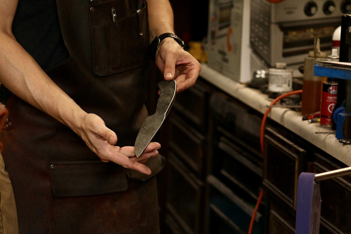 Andrew Hall, recent winner on "Forged in Fire," a competition TV series, shows a blade he forged in the garage workshop of his home in Coeur d'Alene. HANNAH NEFF/Press