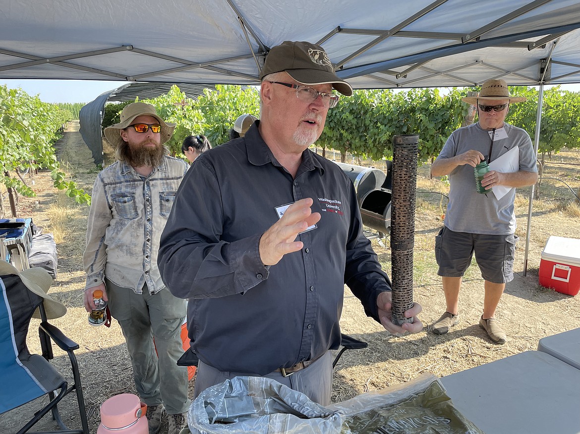 WSU researcher Tom Collins shows a metal tube filled with wood pellets used to create smoke as part of his research into the effects of wildfire smoke on grapes and grapevines.