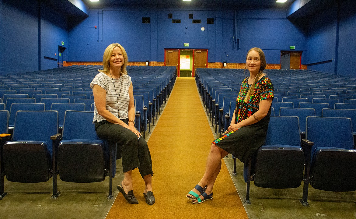 Columbia Basin Allied Arts board member Leslie Ramsden, left, and executive director Shawn Cardwell stand on opposite sides of the aisle in the Wallenstien Theater in Moses Lake July 8.