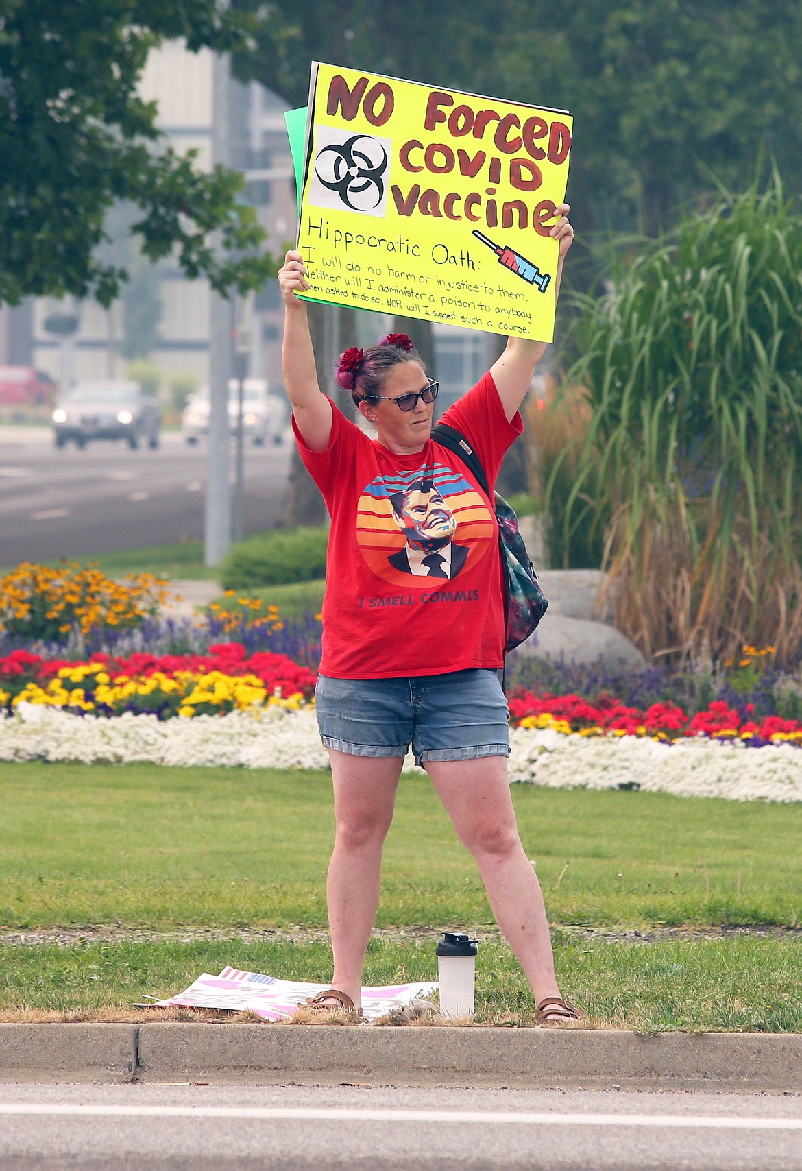 Joy Gibson holds a sign during Thursday's rally in Coeur d'Alene opposing vaccine mandates for those in the medical field.
