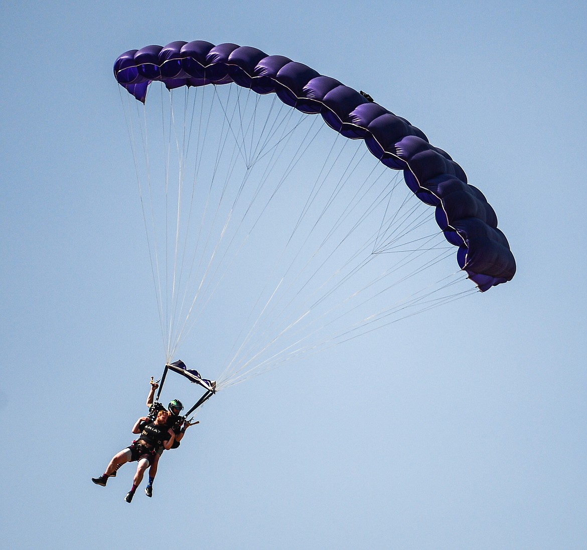 Tandem skydivers descend over the 2021 Skydive Lost Prairie Boogie at Meadow Peak Skydiving near Marion on Thursday, Aug. 12, 2021. (Casey Kreider/Daily Inter Lake)