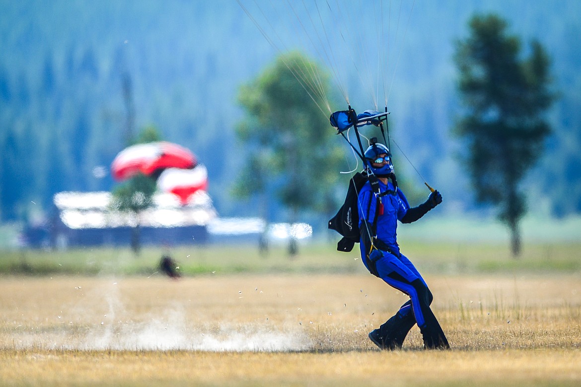A skydiver skids across the ground during a landing at the 2021 Skydive Lost Prairie Boogie at Meadow Peak Skydiving near Marion on Thursday, Aug. 12, 2021. (Casey Kreider/Daily Inter Lake)